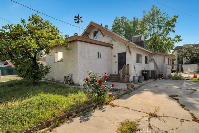 bungalow-style home with fence and stucco siding