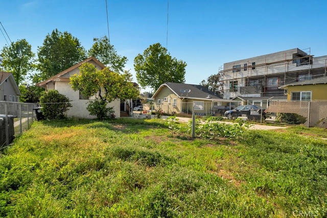 view of yard with central AC and fence