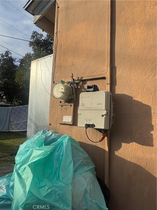 details with electric meter and stucco siding