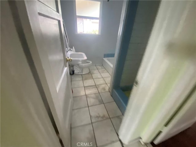 bathroom with toilet, walk in shower, and tile patterned floors