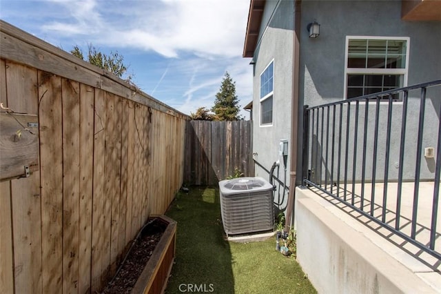 view of property exterior featuring central air condition unit, a fenced backyard, and stucco siding