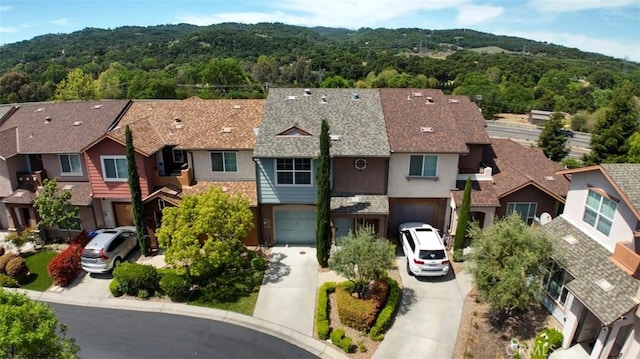 bird's eye view featuring a view of trees and a residential view