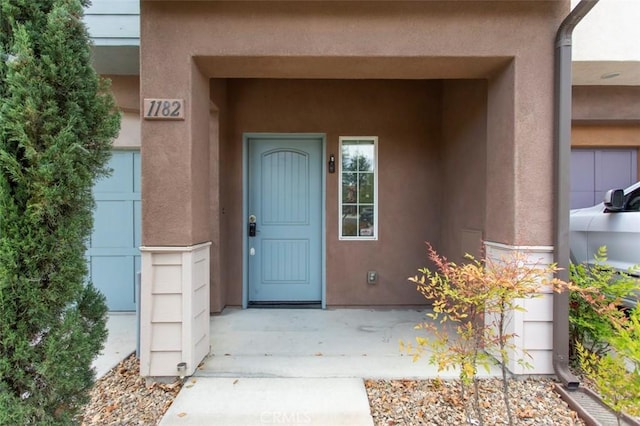 doorway to property with stucco siding