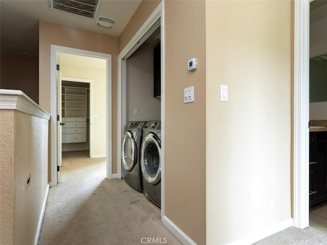 laundry area featuring visible vents, laundry area, carpet, and washing machine and clothes dryer