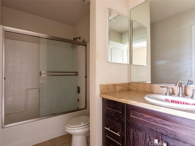 full bathroom featuring toilet, tile patterned flooring, shower / bath combination with glass door, and vanity