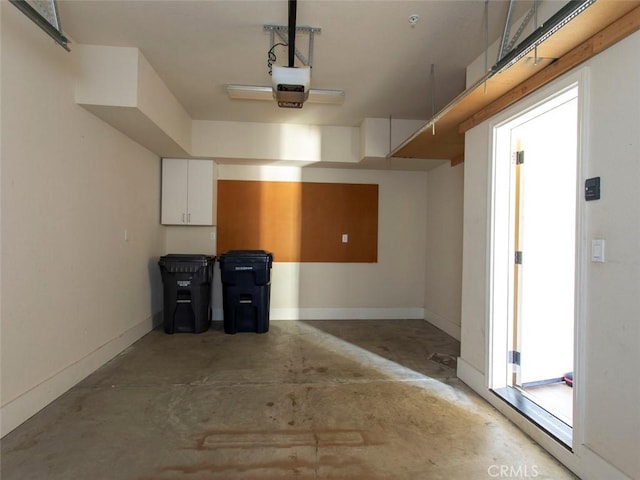 garage with baseboards and a garage door opener