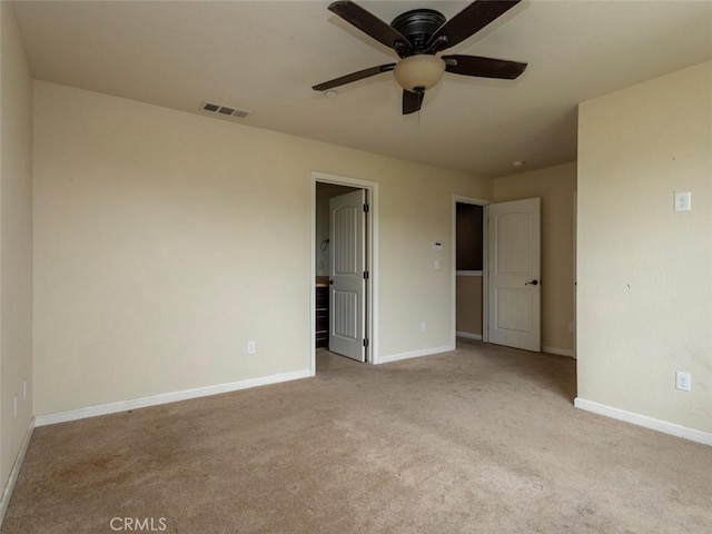 unfurnished bedroom with ceiling fan, carpet, baseboards, ensuite bathroom, and visible vents