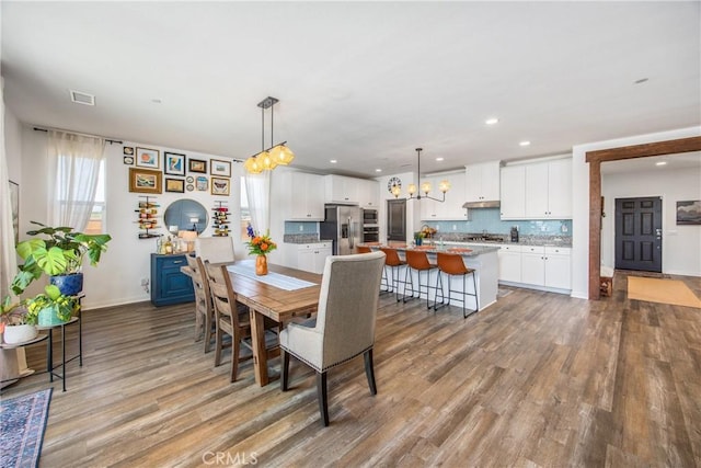dining area featuring visible vents, baseboards, an inviting chandelier, recessed lighting, and light wood-style flooring