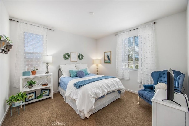 carpeted bedroom with baseboards