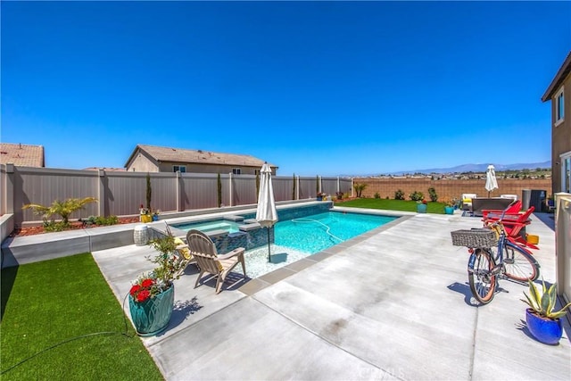 view of pool featuring a fenced backyard, a patio area, and a pool with connected hot tub