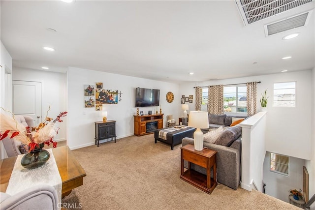 living room with baseboards, light colored carpet, recessed lighting, and visible vents