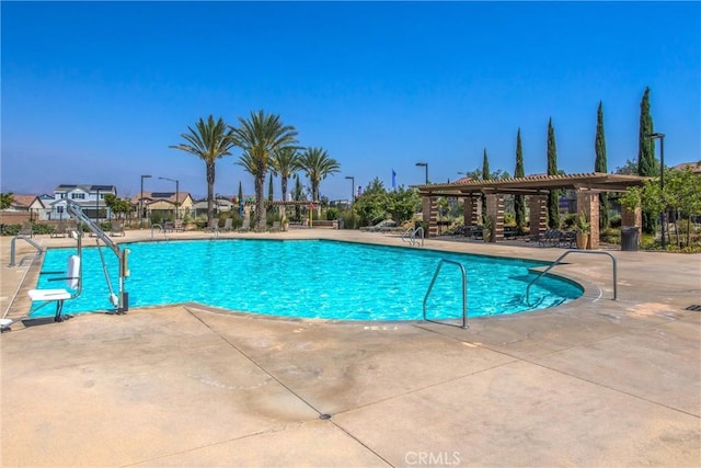 community pool with a patio and a pergola