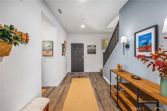entryway featuring visible vents, stairs, baseboards, dark wood-style floors, and recessed lighting