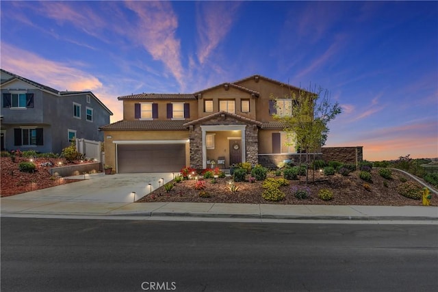 view of front of home with fence, stucco siding, a tiled roof, an attached garage, and driveway