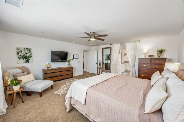 bedroom with connected bathroom, a ceiling fan, visible vents, and carpet