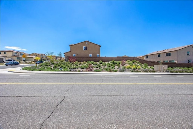 view of road featuring a residential view, sidewalks, and curbs