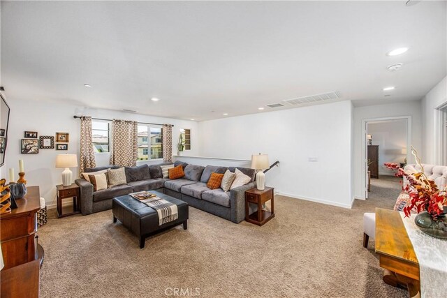 living area featuring recessed lighting, baseboards, visible vents, and carpet