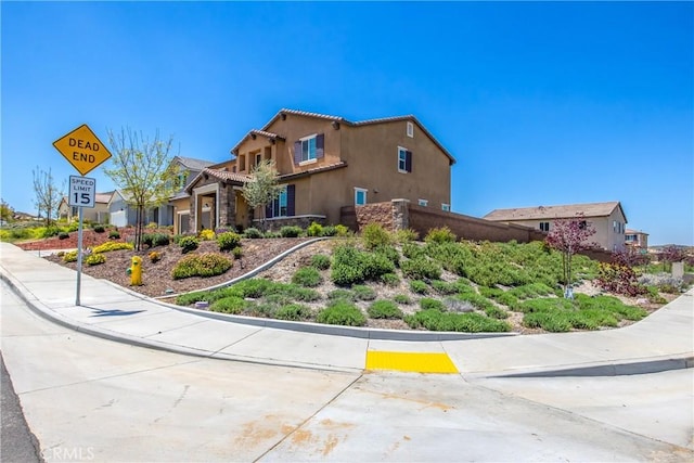 view of property exterior featuring a tiled roof and stucco siding