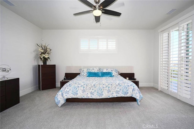 bedroom with visible vents, carpet floors, and multiple windows
