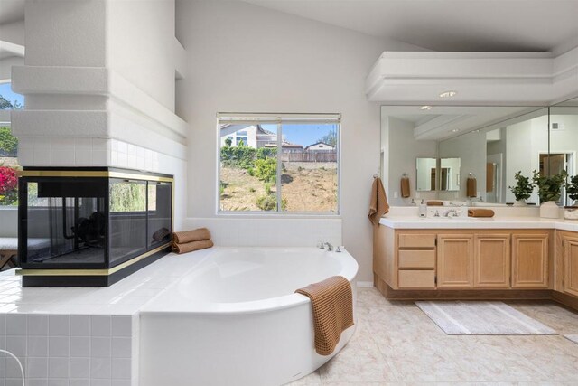 1366 Via Cibola, Oceanside, CA 92057 - full bath with a tiled fireplace, a healthy amount of sunlight, a garden tub, and vanity