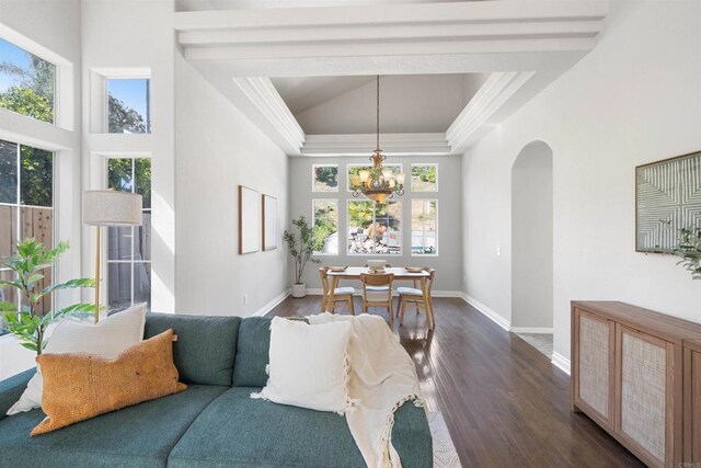 1366 Via Cibola, Oceanside, CA 92057 - living area featuring a healthy amount of sunlight, baseboards, an inviting chandelier, and dark wood-style flooring