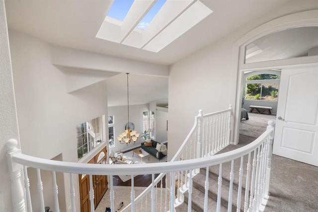 1366 Via Cibola, Oceanside, CA 92057 - hall featuring carpet flooring, a chandelier, a skylight, and an upstairs landing