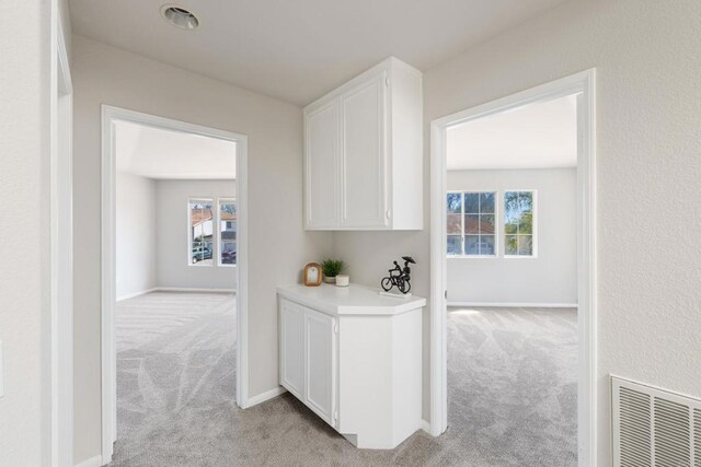 1366 Via Cibola, Oceanside, CA 92057 - corridor with light colored carpet, baseboards, and visible vents