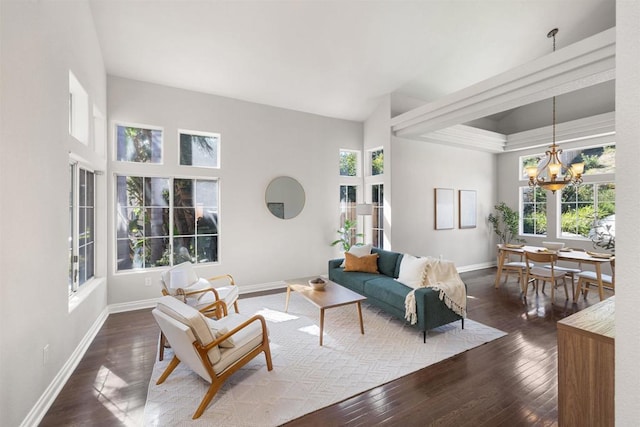 1366 Via Cibola, Oceanside, CA 92057 - living room with an inviting chandelier, baseboards, a wealth of natural light, and dark wood-style floors