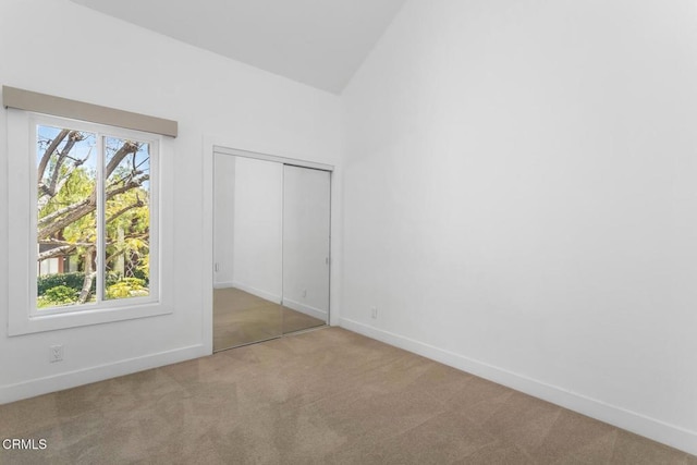 unfurnished bedroom with carpet floors, baseboards, and a closet