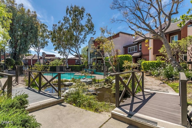 view of pool with fence, a wooden deck, and a fenced in pool