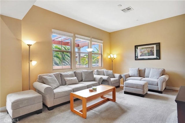 living area featuring baseboards, light colored carpet, and visible vents