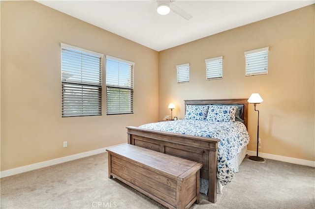 bedroom featuring baseboards, ceiling fan, and light carpet