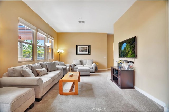 living area with visible vents, carpet, and baseboards
