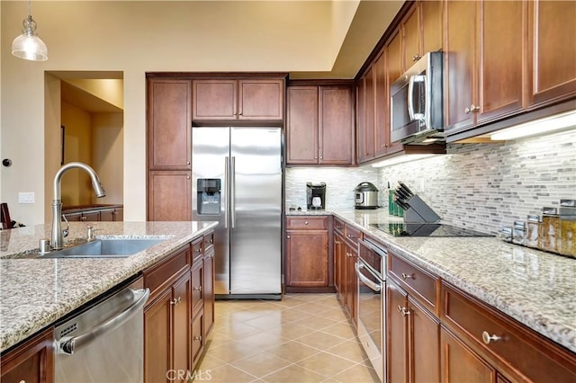 kitchen featuring backsplash, stainless steel appliances, light tile patterned flooring, and a sink