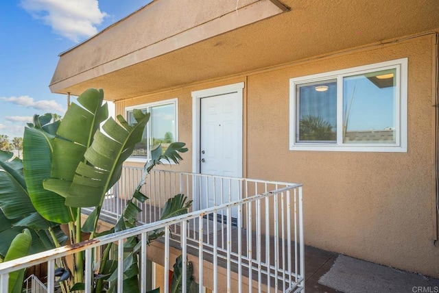 view of exterior entry featuring stucco siding