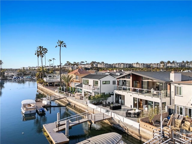 view of dock with a water view and a residential view
