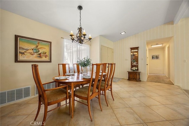 dining room with a notable chandelier, visible vents, wallpapered walls, and light tile patterned floors