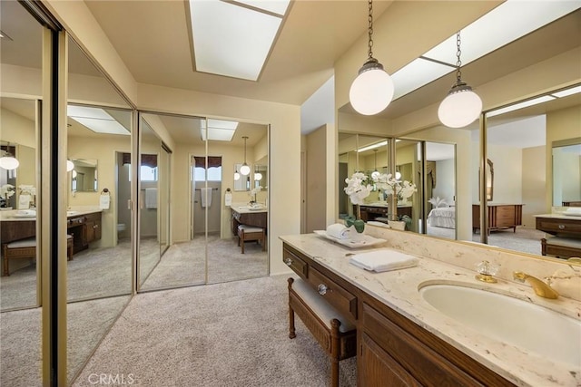 full bathroom with vanity and connected bathroom