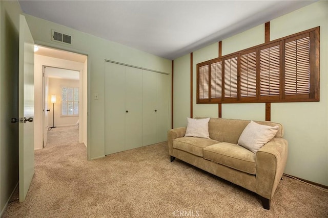 living area featuring carpet floors and visible vents
