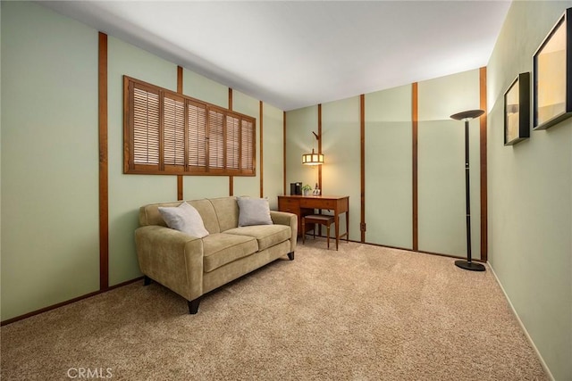 carpeted living room featuring baseboards