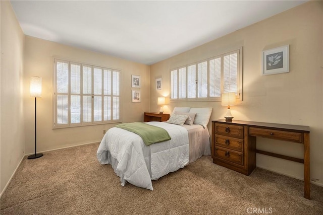 carpeted bedroom with baseboards