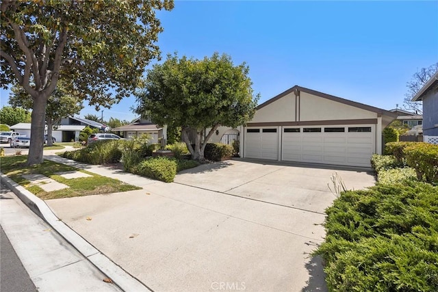 ranch-style house with a garage, stucco siding, and concrete driveway