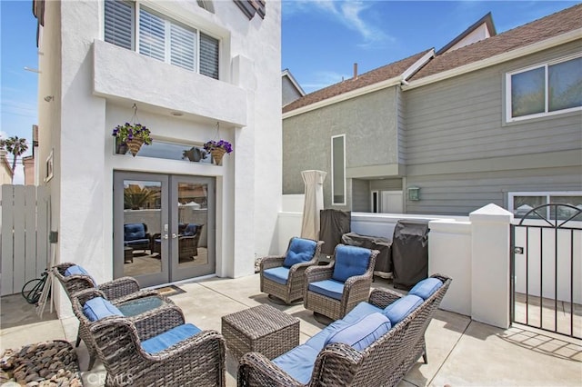 view of patio / terrace with fence, french doors, and an outdoor hangout area