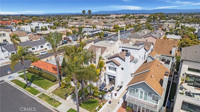 drone / aerial view featuring a residential view and a mountain view