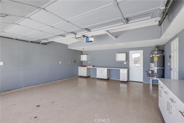 garage with strapped water heater and a garage door opener