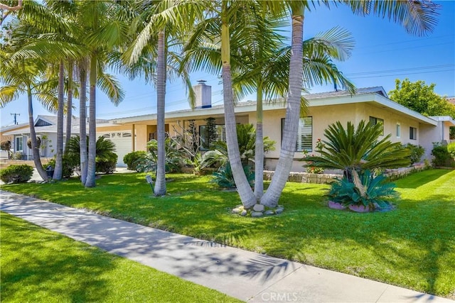 view of front of home with stucco siding and a front lawn