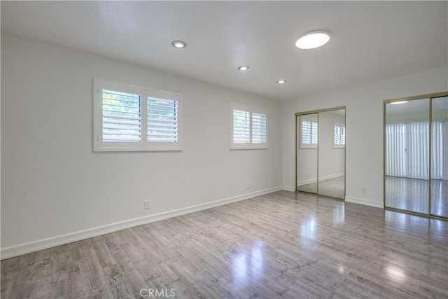 unfurnished bedroom with baseboards, recessed lighting, and wood finished floors