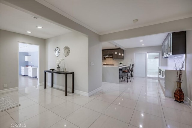 corridor with recessed lighting, baseboards, and light tile patterned floors