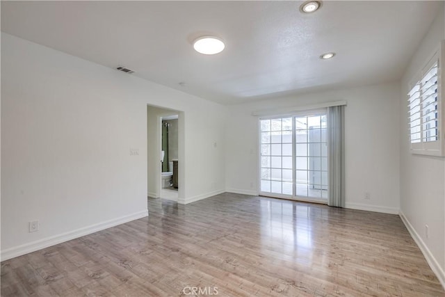 unfurnished room featuring recessed lighting, baseboards, visible vents, and wood finished floors