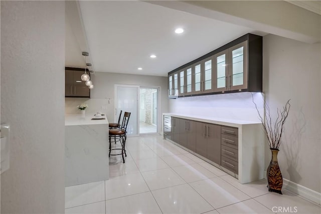 kitchen featuring recessed lighting, light countertops, modern cabinets, and light tile patterned floors